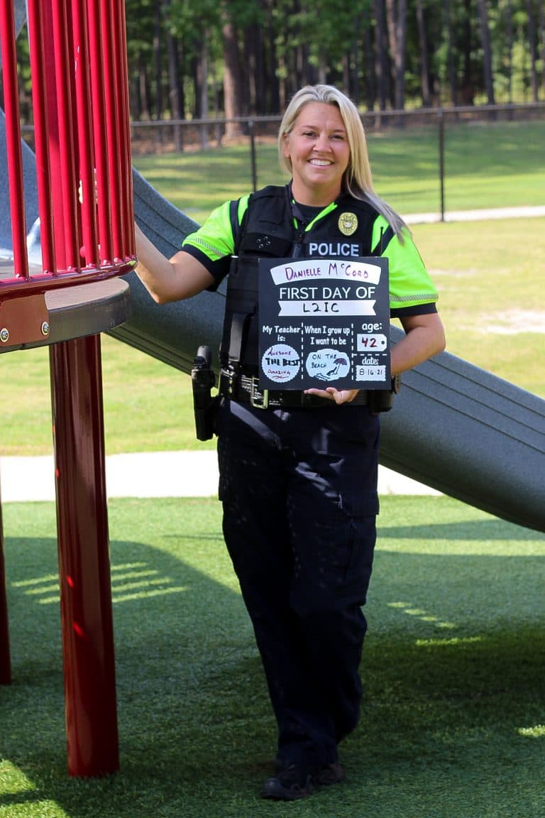 School Resource Officer Lieutenant Danielle McCord next to playground