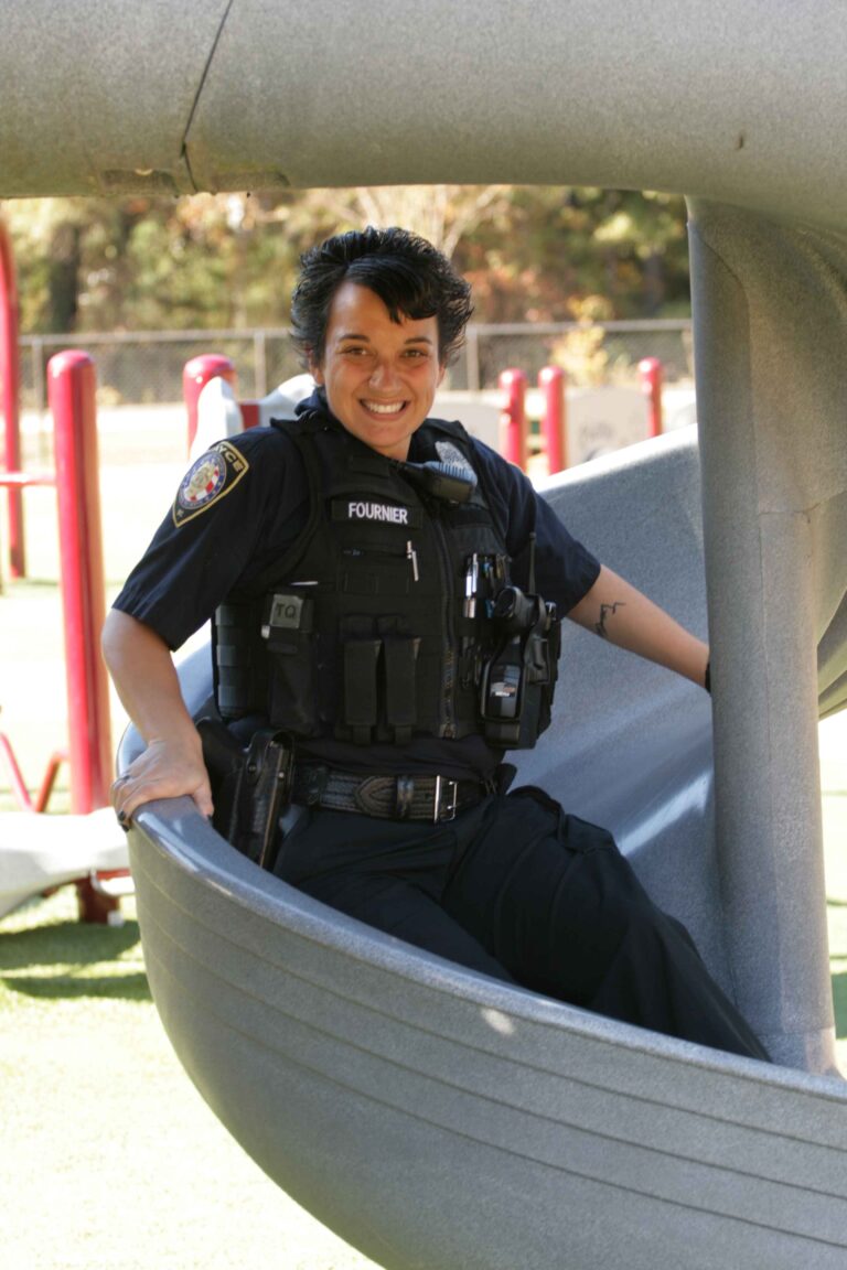 School Resource Officer Fournier on a playground slide