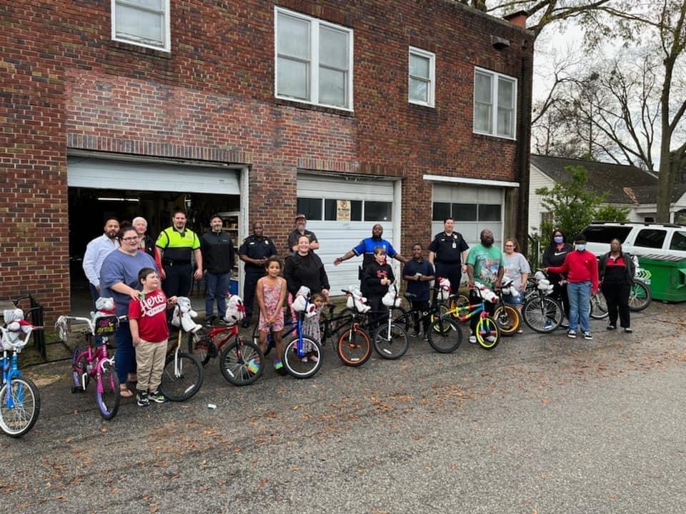 Cayce officers and participants of a child bike giveaway